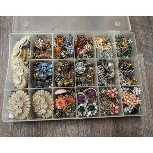 Lot of 108 pairs of ladies clip on earrings in wearable condition in container